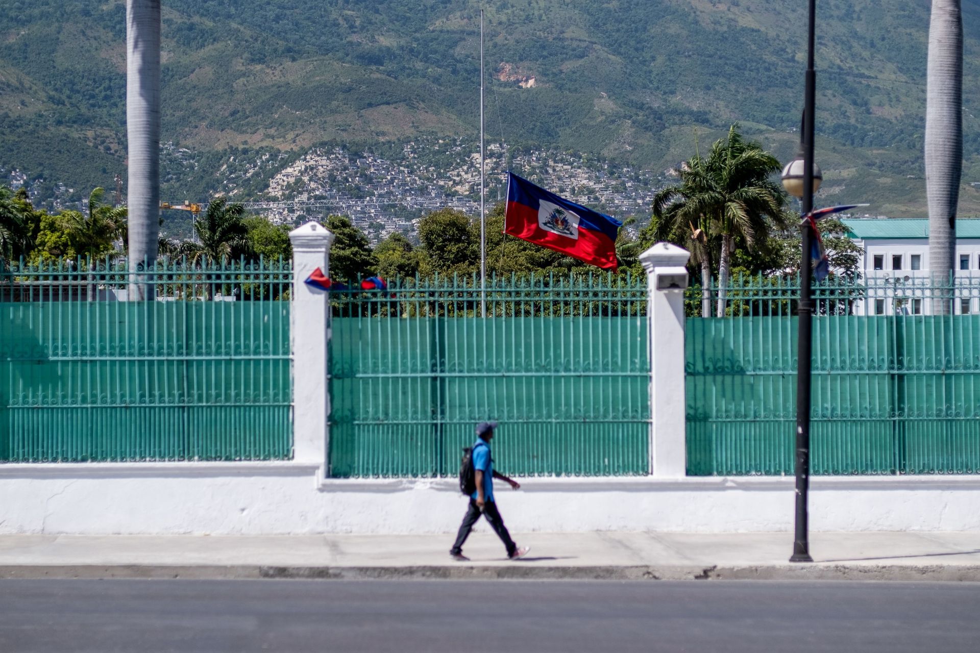 A man walks past in front of where the Haitian Presidential Palace used to be with the Haitian national flag at half-mast, following the assassination of President Jovenel Moise, in Port-au-Prince, Haiti July 10, 2021. - Sputnik International, 1920, 07.09.2021