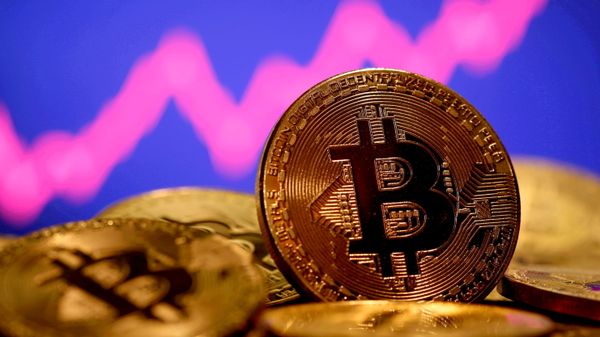 A representation of virtual currency Bitcoin is seen in front of a stock graph in this illustration taken January 8, 2021 - Sputnik International