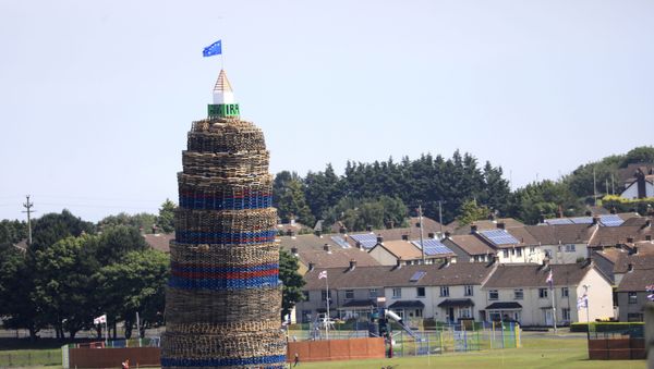 A loyalist bonfire towers above houses in the Craigyhill estate in Larne, Northern Ireland - Sputnik International
