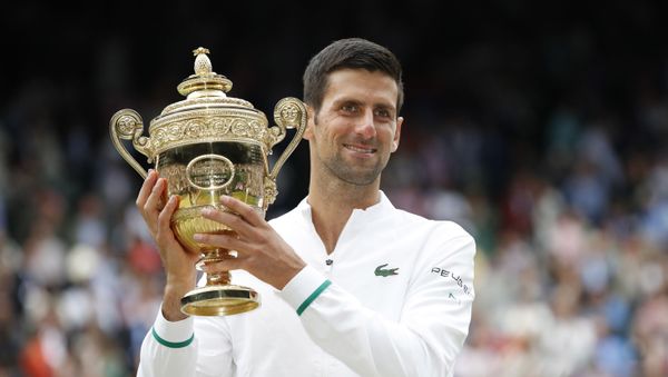 Tennis - Wimbledon - All England Lawn Tennis and Croquet Club, London, Britain - July 11, 2021 Serbia's Novak Djokovic celebrates with the trophy after winning his final match against Italy's Matteo Berrettini Tennis - Wimbledon - All England Lawn Tennis and Croquet Club, London, Britain - July 11, 2021 Serbia's Novak Djokovic celebrates with the trophy after winning his final match against Italy's Matteo Berrettini - Sputnik International