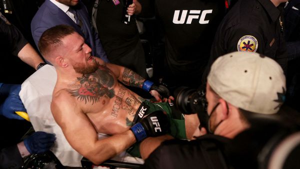 (FILES) In this file photo Conor McGregor of Ireland is carried out of the arena on a stretcher after injuring his ankle in the first round of his lightweight bout against Dustin Poirier during UFC 264: Poirier v McGregor 3 at T-Mobile Arena on July 10, 2021 in Las Vegas, Nevada.  - Sputnik International
