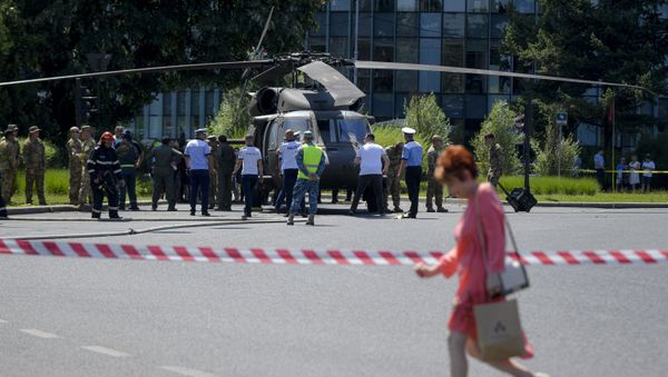 Servicemen walk by a U.S military Black Hawk helicopter following an emergency landing on a busy boulevard, in Bucharest, Romania, Thursday, July 15, 2021 - Sputnik International
