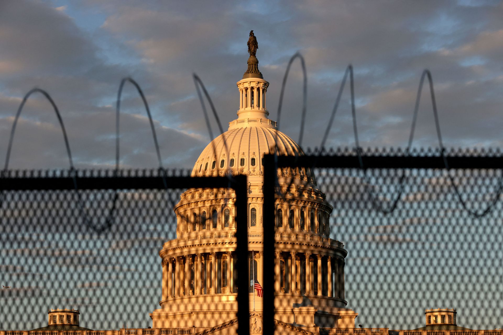 The U.S. Capitol is seen behind a fence with razor wire during sunrise on January 16, 2021 in Washington, DC. After last week's riots at the U.S. Capitol Building, the FBI has warned of additional threats in the nation's capital and in all 50 states. According to reports, as many as 25,000 National Guard soldiers will be guarding the city as preparations are made for the inauguration of Joe Biden as the 46th U.S. President. The U.S. Capitol is seen behind a fence with razor wire during sunrise on January 16, 2021 in Washington, DC. After last week's riots at the U.S. Capitol Building, the FBI has warned of additional threats in the nation's capital and in all 50 states. According to reports, as many as 25,000 National Guard soldiers will be guarding the city as preparations are made for the inauguration of Joe Biden as the 46th U.S. President. - Sputnik International, 1920, 19.01.2025