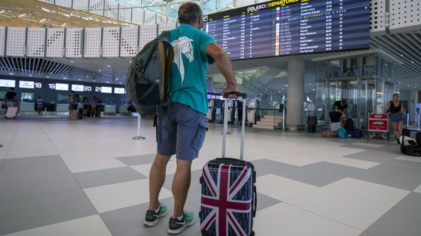 In this Friday, Aug. 21, 2021 file photo, a passenger inspects the departures timetable at the international airport in Split, Croatia - Sputnik International