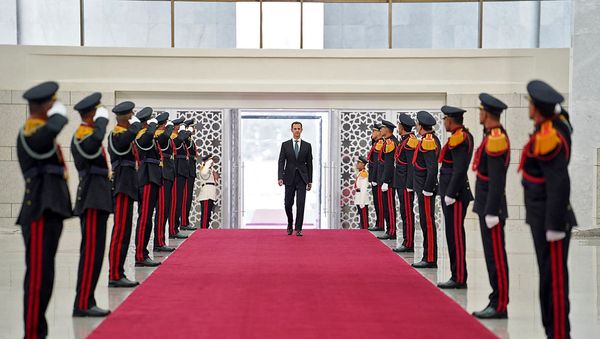 A handout picture released by the official Facebook page of the Syrian Presidency shows President Bashar al-Assad arriving to the swearing-in ceremony for his fourth term, in the capital Damascus, on July 17, 2021. - Sputnik International