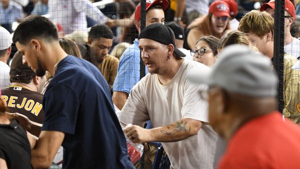 Fans run onto the field for cover after shots are heard from a shooting outside the stadium that sent players and fans seeking shelter during a baseball game between the San Diego Padres and the Washington Nationals at Nationals Park on July 17, 2021 in Washington, DC.   - Sputnik International