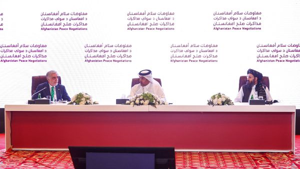 (L to R) The head of Afghanistan's High Council for National Reconciliation Abdullah Abdullah, Qatar's envoy on counter-terrorism Mutlaq al-Qahtani, and the leader of the Taliban negotiating team Mullah Abdul Ghani Baradar present the final declaration of the peace talks between the Afghan government and the Taliban in Qatar's capital Doha on July 18, 2021 - Sputnik International