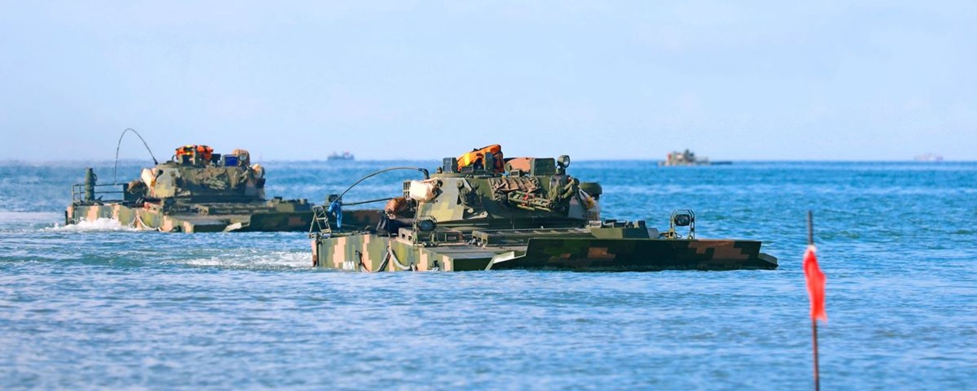 Amphibious armored infantry fighting vehicles (IFV) attached to a brigade under the PLA 72nd Group Army drive into the waters during an amphibious training exercise focused on subjects of basic driving, landing craft ferrying and assault wave formation, etc. on May 21, 2021 Amphibious armored infantry fighting vehicles (IFV) attached to a brigade under the PLA 72nd Group Army drive into the waters during an amphibious training exercise focused on subjects of basic driving, landing craft ferrying and assault wave formation, etc. on May 21, 2021 - Sputnik International, 1920, 28.02.2024
