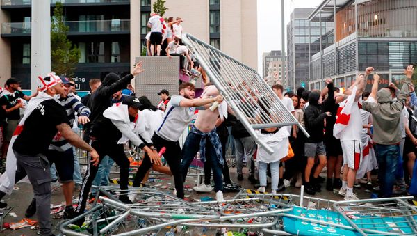Soccer Football - Euro 2020 - Final - Fans gather for Italy v England - Wembley Stadium, London, Britain - July 11, 2021 Picture taken July 11, 2021 England fans throw barriers outside Wembley Stadium during the match Action Images via Reuters/Lee Smith - Sputnik International