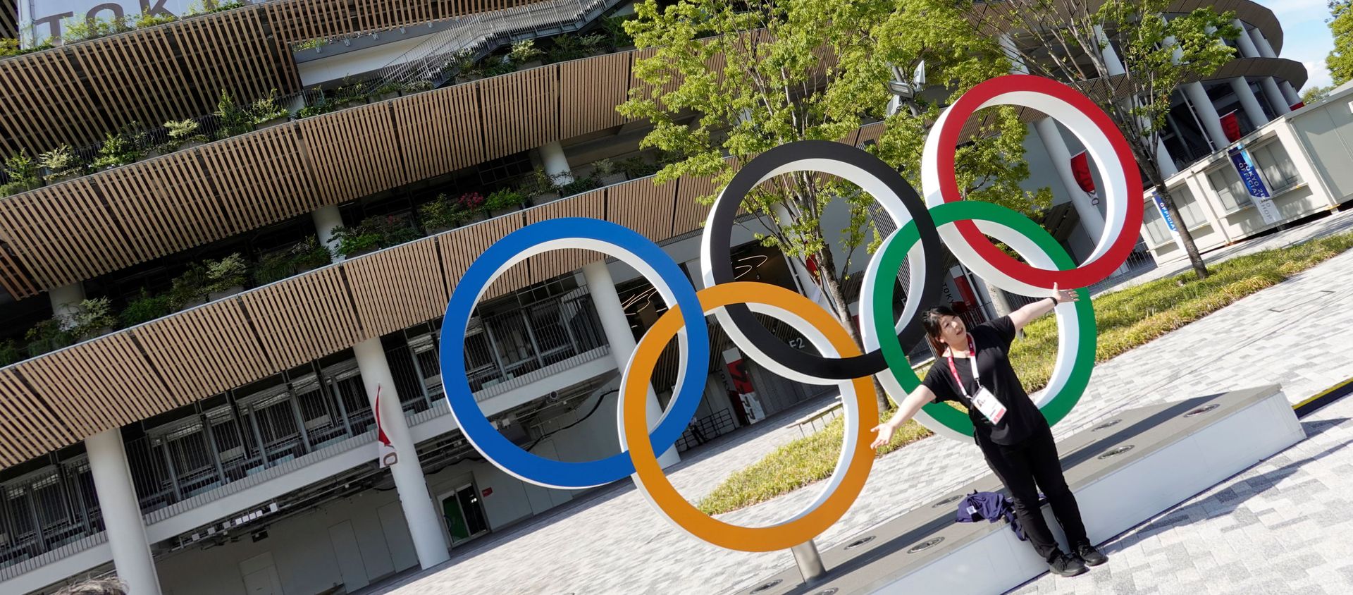 A woman poses in front of the National Stadium, the main stadium of Tokyo 2020 Olympics and Paralympics in Tokyo, Japan July 23, 2021. - Sputnik International, 1920, 01.08.2021