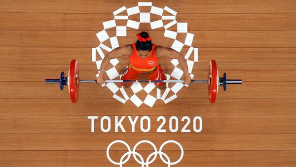 Tokyo 2020 Olympics - Weightlifting - Women's 49kg - Group A - Tokyo International Forum, Tokyo, Japan - July 24, 2021. Mirabai Chanu Saikhom of India in action. Pool via REUTERS/Chris Graythen Tokyo 2020 Olympics - Weightlifting - Women's 49kg - Group A - Tokyo International Forum, Tokyo, Japan - July 24, 2021. Mirabai Chanu Saikhom of India in action. Pool via REUTERS/Chris Graythen - Sputnik International
