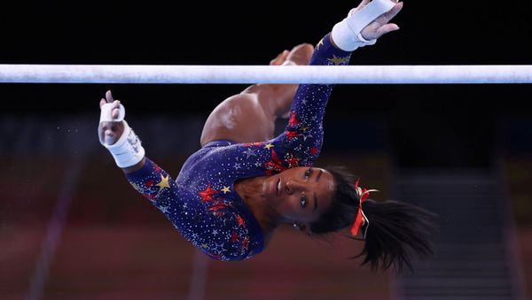 Tokyo 2020 Olympics - Gymnastics - Artistic - Women's Uneven Bars - Qualification - Ariake Gymnastics Centre, Tokyo, Japan - July 25, 2021. Simone Biles of the United States in action during the uneven bars REUTERS/Mike Blake/File photo SEARCH OLYMPICS DAY 3 FOR TOKYO 2020 OLYMPICS EDITOR'S CHOICE, SEARCH REUTERS OLYMPICS TOPIX FOR ALL EDITOR'S CHOICE PICTURES. Tokyo 2020 Olympics - Gymnastics - Artistic - Women's Uneven Bars - Qualification - Ariake Gymnastics Centre, Tokyo, Japan - July 25, 2021. Simone Biles of the United States in action during the uneven bars REUTERS/Mike Blake/File photo SEARCH OLYMPICS DAY 3 FOR TOKYO 2020 OLYMPICS EDITOR'S CHOICE, SEARCH REUTERS OLYMPICS TOPIX FOR ALL EDITOR'S CHOICE PICTURES. - Sputnik International