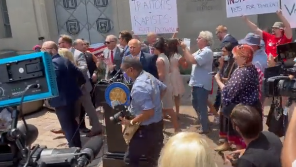 US Reps. Matt Gaetz (R-FL), Marjorie Taylor Greene (R-GA), Louie Gohmert (R-TX) and Paul Gosar (R-AZ) flee from protesters outside the US Department of Justice on July 27, 2021 - Sputnik International