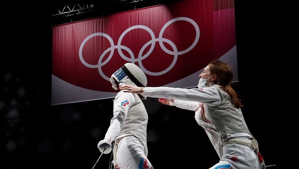 Tokyo 2020 Olympics - Fencing - Women's Team Foil - Gold medal match - Makuhari Messe Hall B - Chiba, Japan - July 29, 2021. Inna Deriglazova of the Russian Olympic Committee and Larisa Korobeynikova of the Russian Olympic Committee celebrate after winning gold REUTERS/Maxim Shemetov - Sputnik International