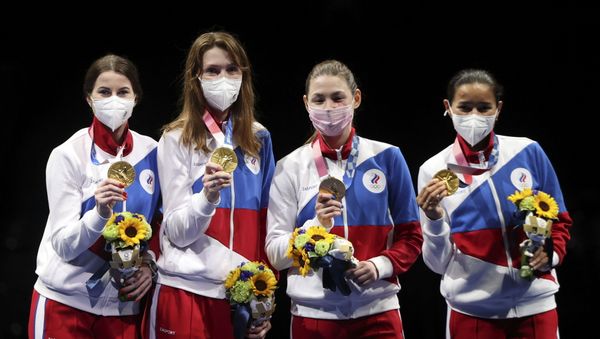 Tokyo 2020 Olympics - Fencing - Women's Team Foil - Medal Ceremony - Makuhari Messe Hall B - Chiba, Japan - July 29, 2021. Gold medallists Inna Deriglazova of the Russian Olympic Committee, Adelina Zagidullina of the Russian Olympic Committee, Larisa Korobeynikova of the Russian Olympic Committee and Marta Martyanova of the Russian Olympic Committee celebrate on the podium REUTERS/Carl Recine - Sputnik International