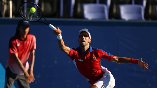 Tokyo 2020 Olympics - Tennis - Men's Singles - Bronze medal match - Ariake Tennis Park - Tokyo, Japan - July 31, 2021. Novak Djokovic of Serbia in action during his bronze medal match against Pablo Carreno of Spain REUTERS/Edgar Su Tokyo 2020 Olympics - Tennis - Men's Singles - Bronze medal match - Ariake Tennis Park - Tokyo, Japan - July 31, 2021. Novak Djokovic of Serbia in action during his bronze medal match against Pablo Carreno of Spain REUTERS/Edgar Su - Sputnik International