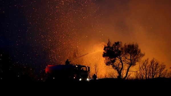 Firefighters try to extinguish a wildfire in the suburb of Varympompi, north of Athens, Greece, August 3, 2021.  - Sputnik International