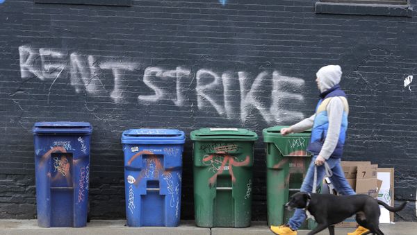 A pedestrian walks past graffiti that reads Rent Strike Wednesday, April 1, 2020, in Seattle's Capitol Hill neighborhood. A pedestrian walks past graffiti that reads Rent Strike Wednesday, April 1, 2020, in Seattle's Capitol Hill neighborhood. - Sputnik International