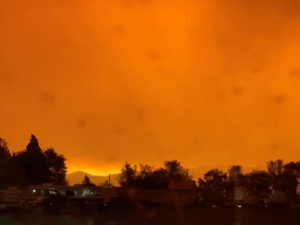 A dark orange sky due to the Dixie fire is seen in Lassen County, California on 5 August 2021 in this screengrab obtained from a social media video. - Sputnik International