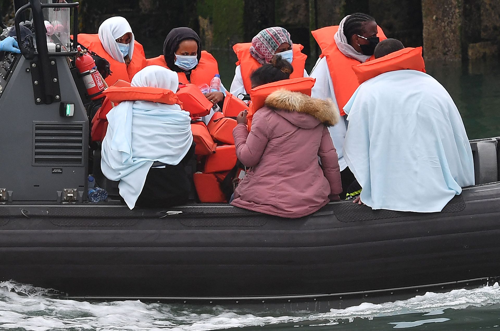 Migrants picked up at sea whilst Crossing the English Channel, but intercepted but intercepted bu UK Border Force officials, travel in a RIB with as they are brought into the Marina in Dover, southeast England on August 15, 2020. (Photo by Ben STANSALL / AFP) - Sputnik International, 1920, 12.09.2021