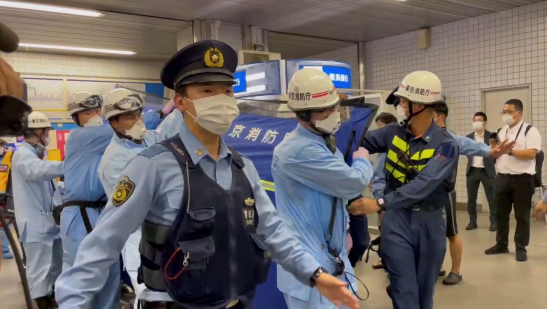 Police escort rescue workers carrying a person through a train station after a knife attack on a train in Tokyo, Japan August 6, 2021 in this still image taken from video obtained by REUTERS   THIS IMAGE HAS BEEN SUPPLIED BY A THIRD PARTY. - Sputnik International, 1920, 08.08.2021