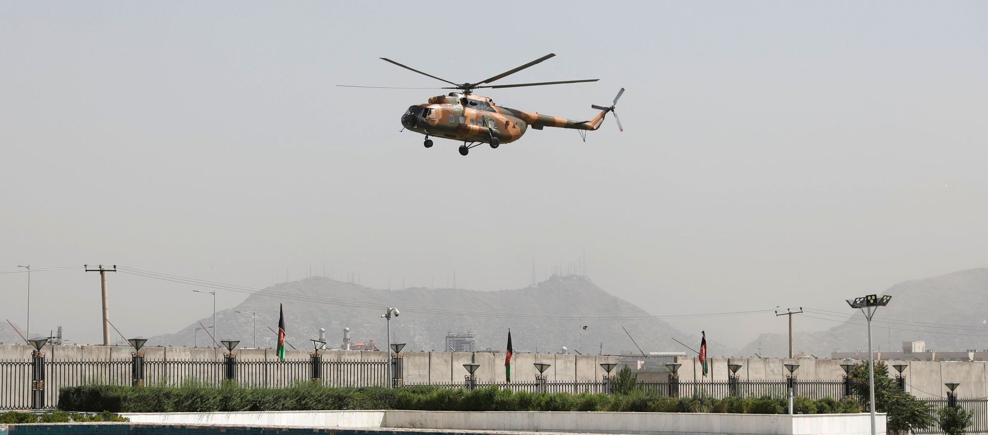 A military helicopter carrying Afghan President Ashraf Ghani prepares to land near the parliament in Kabul, Afghanistan, 2 August 2021 A military helicopter carrying Afghan President Ashraf Ghani prepares to land near the parliament in Kabul, Afghanistan, 2 August 2021 - Sputnik International, 1920, 12.08.2021