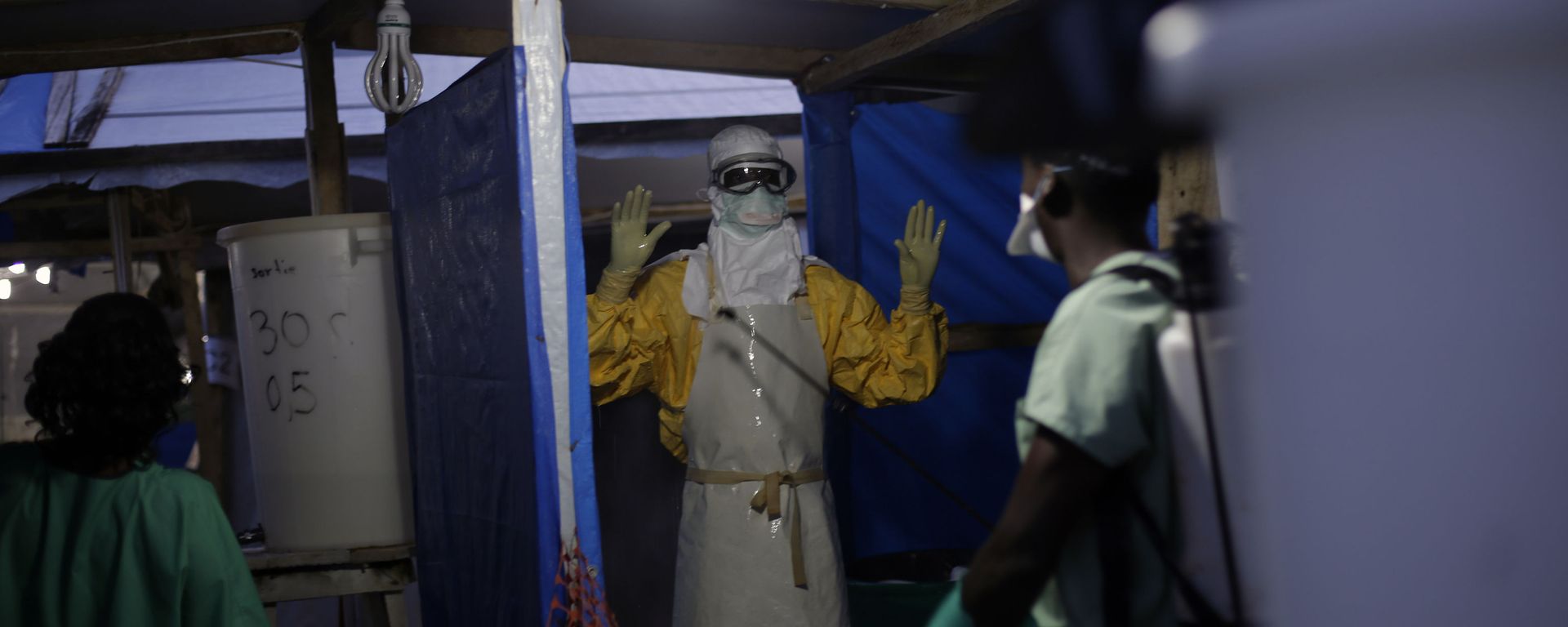 FILE- In this Nov. 20, 2014 file photo, an MSF Ebola heath worker is sprayed as he leaves the contaminated zone at the Ebola treatment centre in Gueckedou, Guinea FILE- In this Nov. 20, 2014 file photo, an MSF Ebola heath worker is sprayed as he leaves the contaminated zone at the Ebola treatment centre in Gueckedou, Guinea - Sputnik International, 1920, 23.08.2022