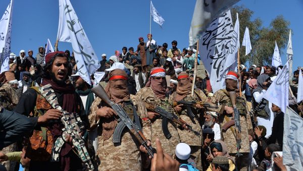 Afghan Taliban militants and villagers attend a gathering as they celebrate the peace deal and their victory in the Afghan conflict on US in Afghanistan, in Alingar district of Laghman Province on March 2, 2020 - Sputnik International
