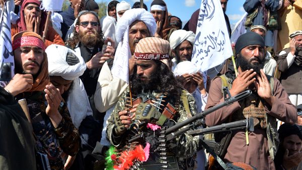 Afghan Taliban militants and villagers attend a gathering as they celebrate the peace deal and their victory in the Afghan conflict on US in Afghanistan, in Alingar district of Laghman Province on March 2, 2020 Afghan Taliban militants and villagers attend a gathering as they celebrate the peace deal and their victory in the Afghan conflict on US in Afghanistan, in Alingar district of Laghman Province on March 2, 2020 - Sputnik International
