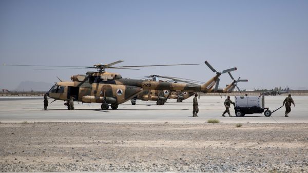Members of Afghanistan's National Army work near military helicopters, in Kandahar Air Field, Afghanistan, Tuesday, Aug. 18, 2015. Since the departure from Afghanistan last year of most international combat troops, Afghan security forces have been fighting the insurgency alone. Figures show that casualty rates are extremely high, reflecting an emboldened Taliban testing the commitment and strength of the Afghan military. (AP Photo/Massoud Hossaini) - Sputnik International