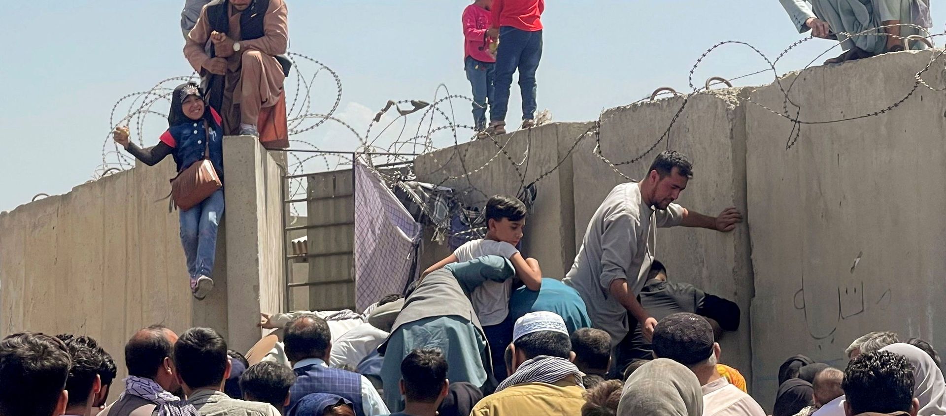A man pulls a girl to get inside Hamid Karzai International Airport in Kabul, Afghanistan August 16, 2021. A man pulls a girl to get inside Hamid Karzai International Airport in Kabul, Afghanistan August 16, 2021. - Sputnik International, 1920