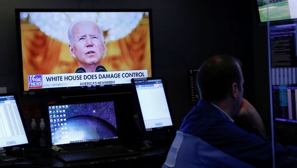 An image of U.S. President Joe Biden is broadcast on a screen after his address to the nation regarding the situation in Afghanistan as traders work on the trading floor of the New York Stock Exchange (NYSE) in Manhattan, New York City, U.S., August 17, 2021. - Sputnik International