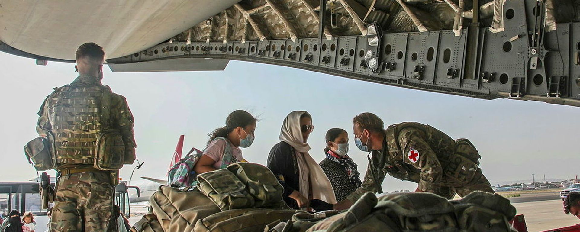 British citizens and dual nationals residing in Afghanistan board a military plane for evacuation from Kabul airport, Afghanistan August 16, 2021, in this handout picture obtained by Reuters on August 17, 2021. - Sputnik International, 1920, 23.08.2021