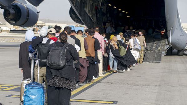 This handout photo courtesy of US Marines Corps shows evacuees stage before boarding a C-17 Globemaster III during an evacuation at Hamid Karzai International Airport, Kabul, Afghanistan, August 18, 2021 - Sputnik International