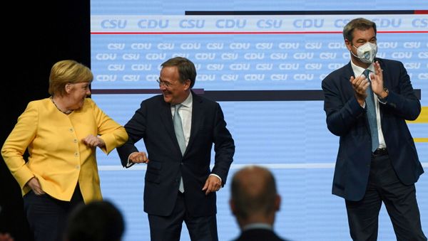 Prime Minister of North Rhine-Westphalia and candidate for chancellor of the CDU/CSU Armin Laschet elbow bumps German Chancellor Angela Merkel as CSU party chief Markus Soeder claps during a CDU/CSU campaign kick off ahead of the federal election at Tempodrom in Berlin, Germany, August 21, 2021. - Sputnik International