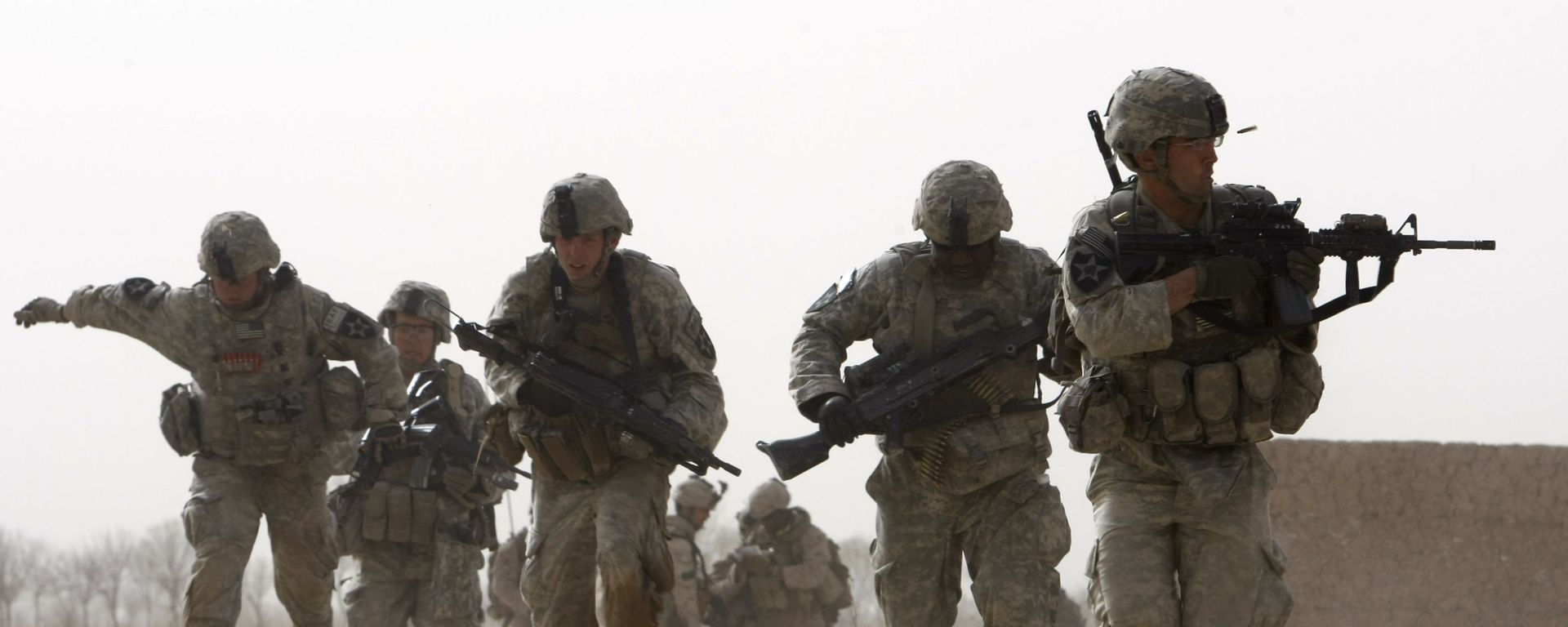 FILE - In this 14 February 2010 file photo, a US soldier returns fire as others run for cover during a firefight with insurgents in the Badula Qulp area, west of Lashkar Gah  in Helmand province, southern Afghanistan - Sputnik International, 1920, 03.09.2021