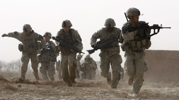FILE - In this Feb. 14, 2010 file photo, a U.S. soldier returns fire as others run for cover during a firefight with insurgents in the Badula Qulp area, west of Lashkar Gah  in Helmand province, southern Afghanistan - Sputnik International