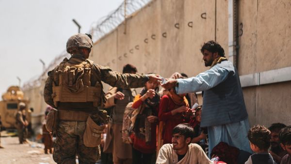 A US Marine passes out water to evacuees during an evacuation at Hamid Karzai International Airport, Kabul, Afghanistan, August 22, 2021 A US Marine passes out water to evacuees during an evacuation at Hamid Karzai International Airport, Kabul, Afghanistan, August 22, 2021 - Sputnik International