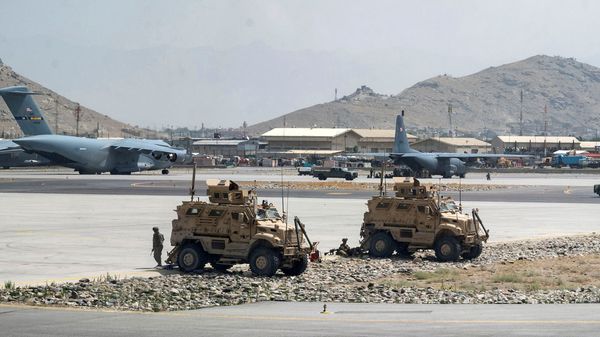FILE PHOTO: FILE PHOTO: U.S. Army soldiers assigned to the 82nd Airborne Division patrol Hamid Karzai International Airport in Kabul, Afghanistan August 17, 2021. Picture taken August 17, 2021.  U.S. Air Force/Senior Airman Taylor Crul/Handout via REUTERS  THIS IMAGE HAS BEEN SUPPLIED BY A THIRD PARTY. THIS PICTURE WAS PROCESSED BY REUTERS TO ENHANCE QUALITY. AN UNPROCESSED VERSION HAS BEEN PROVIDED SEPARATELY./File Photo/File Photo - Sputnik International