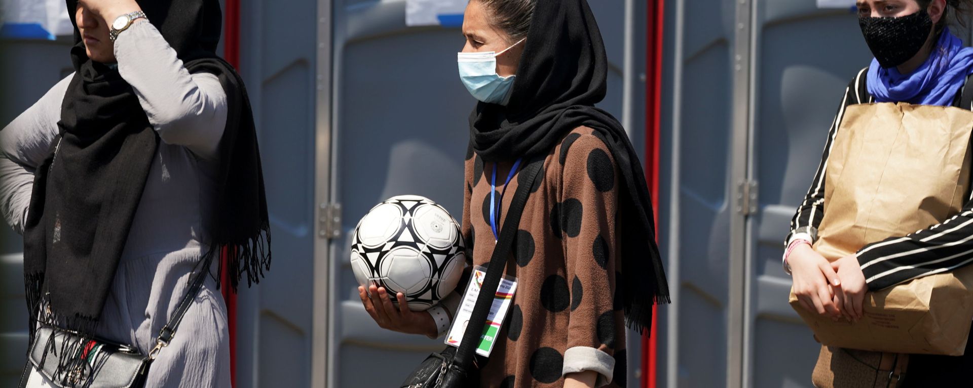 An Afghan woman holding a soccer ball and wearing a CAFA (Central Asian Football Association) credential, waits in line at a processing center for refugees evacuated from Afghanistan at the Dulles Expo Center near Dulles International Airport in Chantilly, Virginia, U.S., August 24, 2021 An Afghan woman holding a soccer ball and wearing a CAFA (Central Asian Football Association) credential, waits in line at a processing center for refugees evacuated from Afghanistan at the Dulles Expo Center near Dulles International Airport in Chantilly, Virginia, U.S., August 24, 2021 - Sputnik International, 1920, 20.09.2021