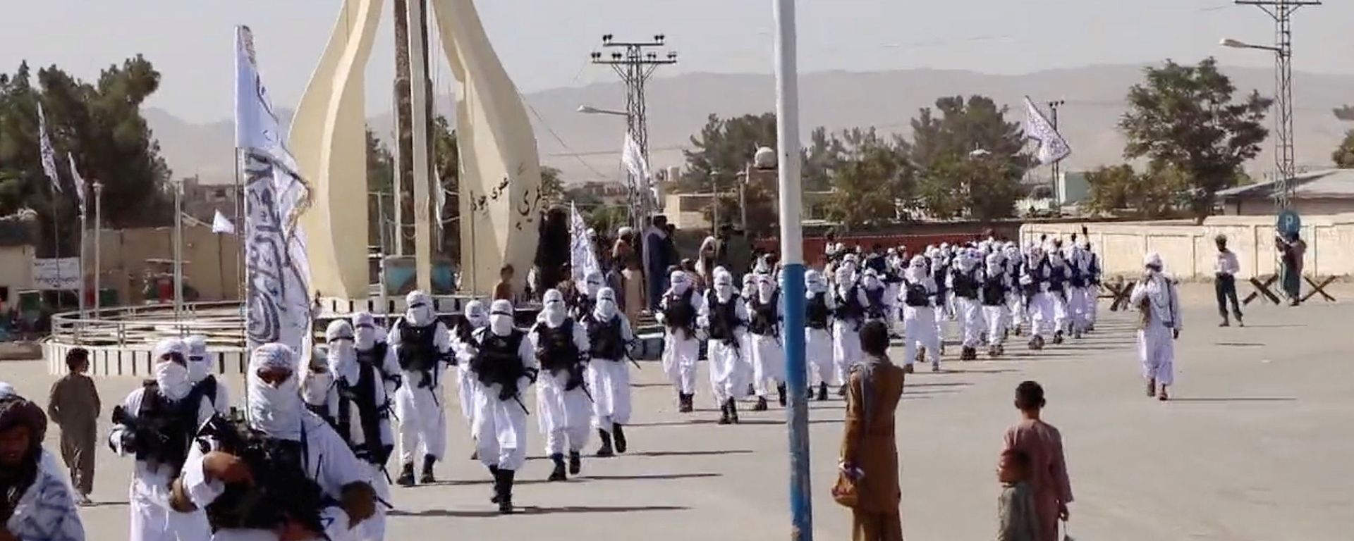 Taliban fighters march in uniforms on the street in Qalat, Zabul Province, Afghanistan, in this still image taken from social media video uploaded August 19, 2021 and obtained by REUTERS Taliban fighters march in uniforms on the street in Qalat, Zabul Province, Afghanistan, in this still image taken from social media video uploaded August 19, 2021 and obtained by REUTERS - Sputnik International, 1920
