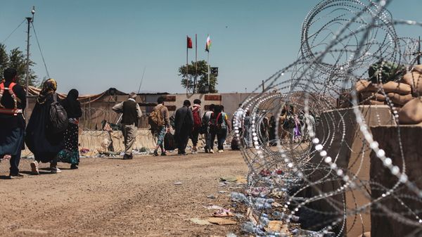 Evacuees walk to be processed during an evacuation at Hamid Karzai International Airport, Kabul, Afghanistan, August 25, 2021. Picture taken August 25, 2021 - Sputnik International