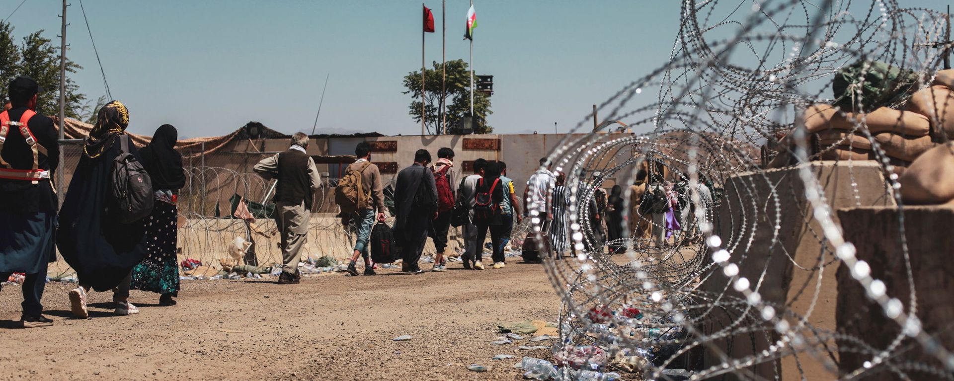 Evacuees walk to be processed during an evacuation at Hamid Karzai International Airport, Kabul, Afghanistan, August 25, 2021. Picture taken August 25, 2021 - Sputnik International, 1920