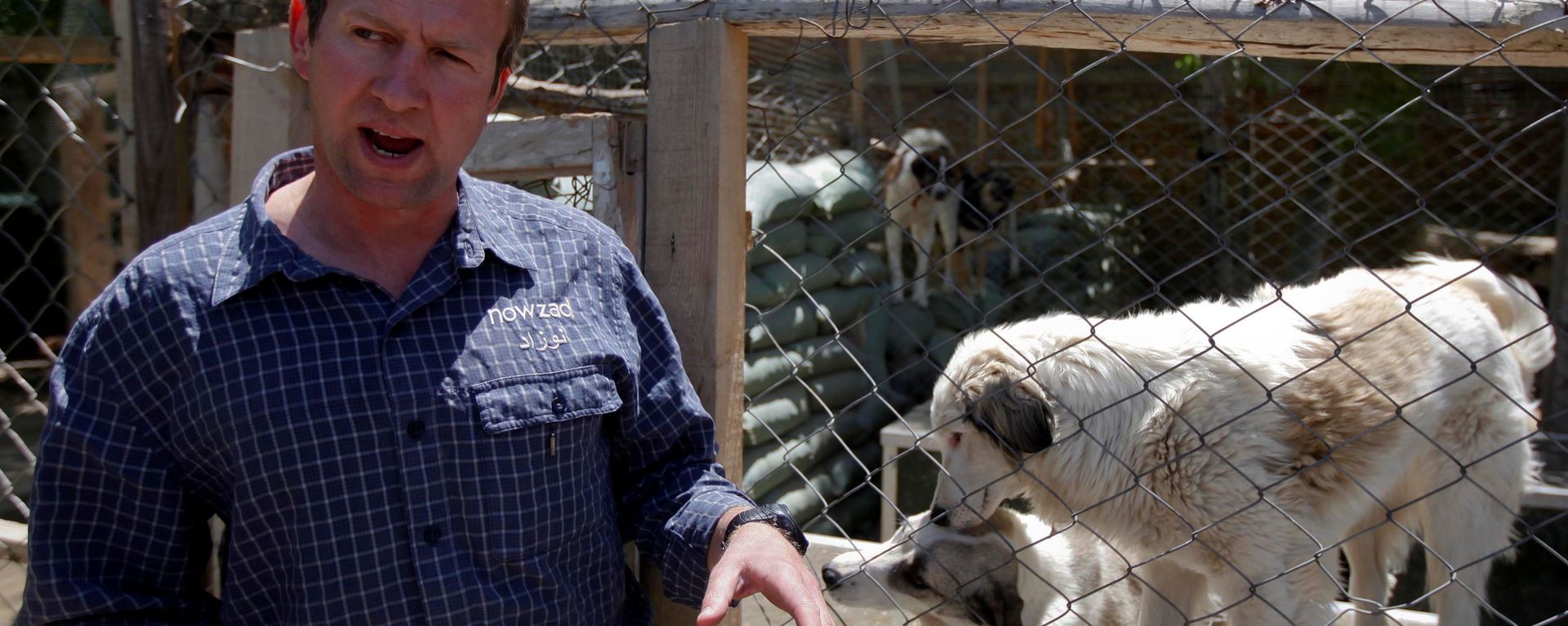 Pen Farthing, founder of British charity Nowzad, an animal shelter, stands in front of a cage on the outskirts of Kabul May 1, 2012. A former Royal Marine, Farthing adopted his dog Nowzad, named after a Helmand district, during his tour there in 2006. He then set up the charity, where dogs and some cats are neutered and vaccinated against rabies before their journeys abroad. Nowzad has given homes to over 330 dogs since it was founded, mostly to soldiers from the U.S. and Britain, but also from South Africa, Australia, Canada and the Netherlands. Picture taken May 1, 2012. Pen Farthing, founder of British charity Nowzad, an animal shelter, stands in front of a cage on the outskirts of Kabul May 1, 2012. A former Royal Marine, Farthing adopted his dog Nowzad, named after a Helmand district, during his tour there in 2006. He then set up the charity, where dogs and some cats are neutered and vaccinated against rabies before their journeys abroad. Nowzad has given homes to over 330 dogs since it was founded, mostly to soldiers from the U.S. and Britain, but also from South Africa, Australia, Canada and the Netherlands. Picture taken May 1, 2012. - Sputnik International, 1920, 29.08.2021