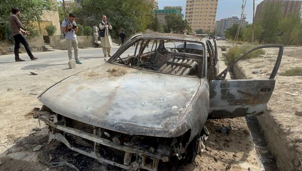 Afghan men take pictures of a vehicle from which rockets were fired, in Kabul - Sputnik International