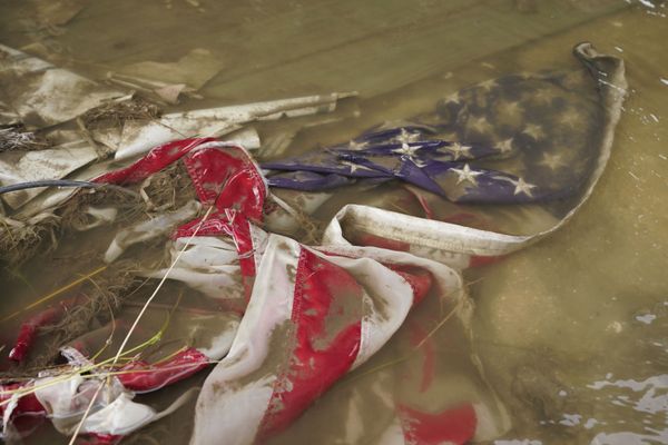 In the aftermath of Hurricane Ida, an American flag floats in a puddle of flood water Wednesday, 1 September 2021, in Myrtle Grove, Louisiana. - Sputnik International