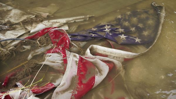 In the aftermath of Hurricane Ida, an American flag floats in a puddle of flood water Wednesday, Sept. 1, 2021, in Myrtle Grove, La.  - Sputnik International