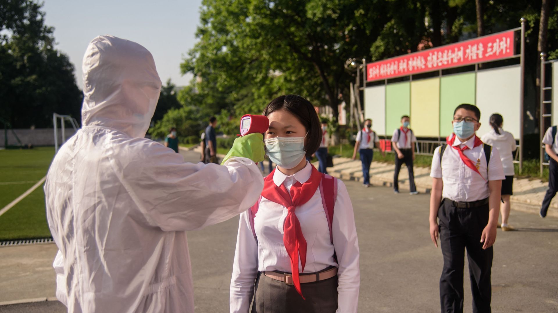 A pupil has her temperature taken as part of an anti-Covid-19 procedures before entering Pyongyang Secondary School No. 1 in Pyongyang on 22 June 2021 A pupil has her temperature taken as part of an anti-Covid-19 procedures before entering Pyongyang Secondary School No. 1 in Pyongyang on 22 June 2021 - Sputnik International, 1920, 03.09.2021