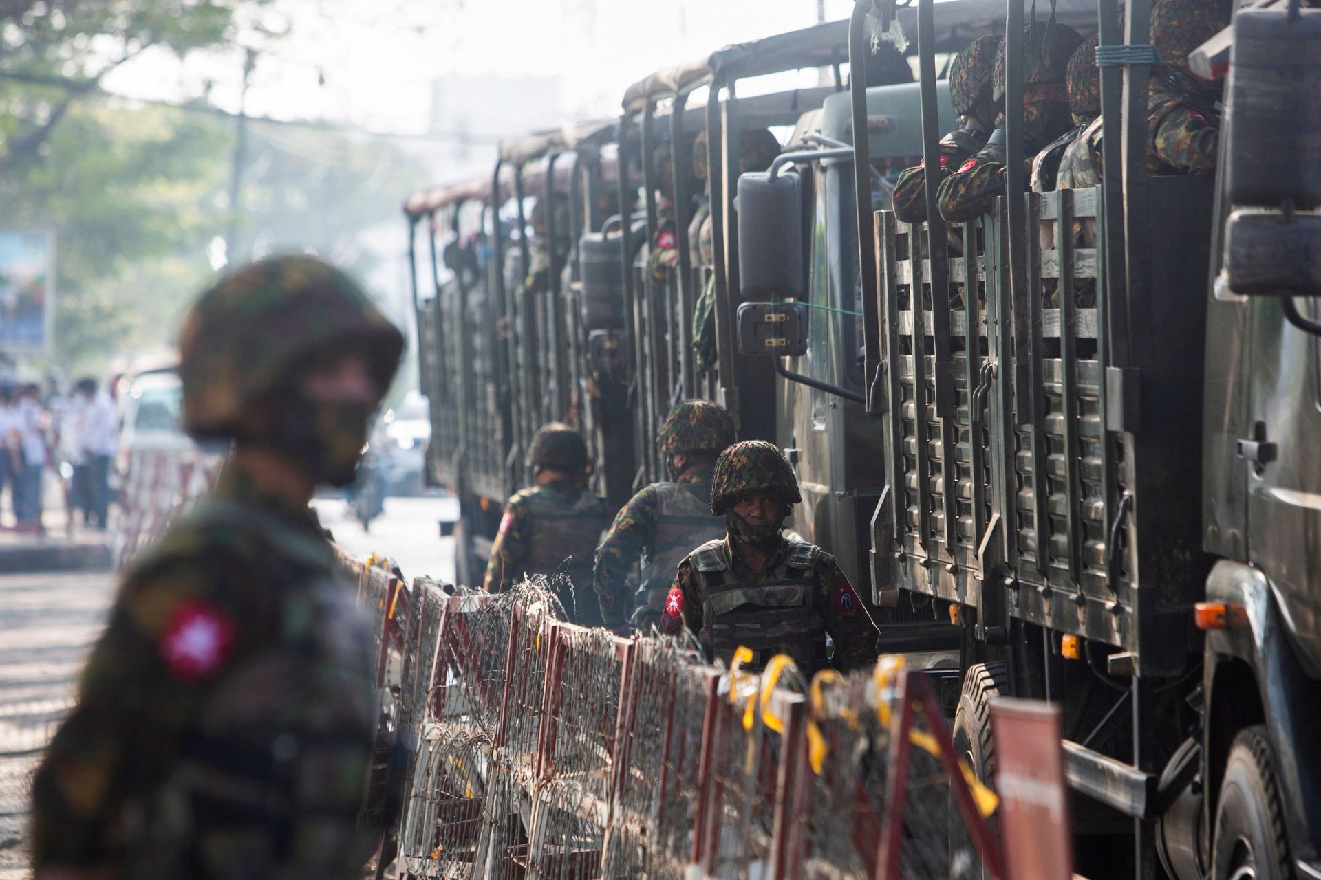 Soldiers stand next to military vehicles as people gather to protest against the military coup, in Yangon, Myanmar, February 15, 2021. - Sputnik International, 1920, 05.10.2021