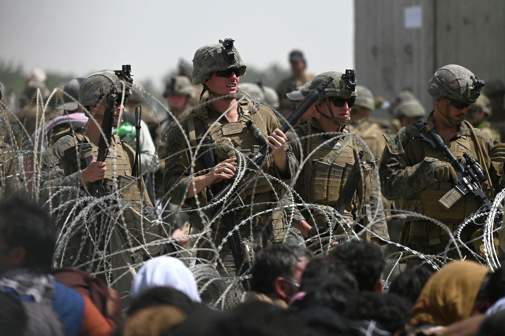 US soldiers stand guard behind barbed wire as Afghans sit on a roadside near the military part of the airport in Kabul on August 20, 2021, hoping to flee from the country after the Taliban's military takeover of Afghanistan US soldiers stand guard behind barbed wire as Afghans sit on a roadside near the military part of the airport in Kabul on August 20, 2021, hoping to flee from the country after the Taliban's military takeover of Afghanistan - Sputnik International, 1920, 07.09.2021